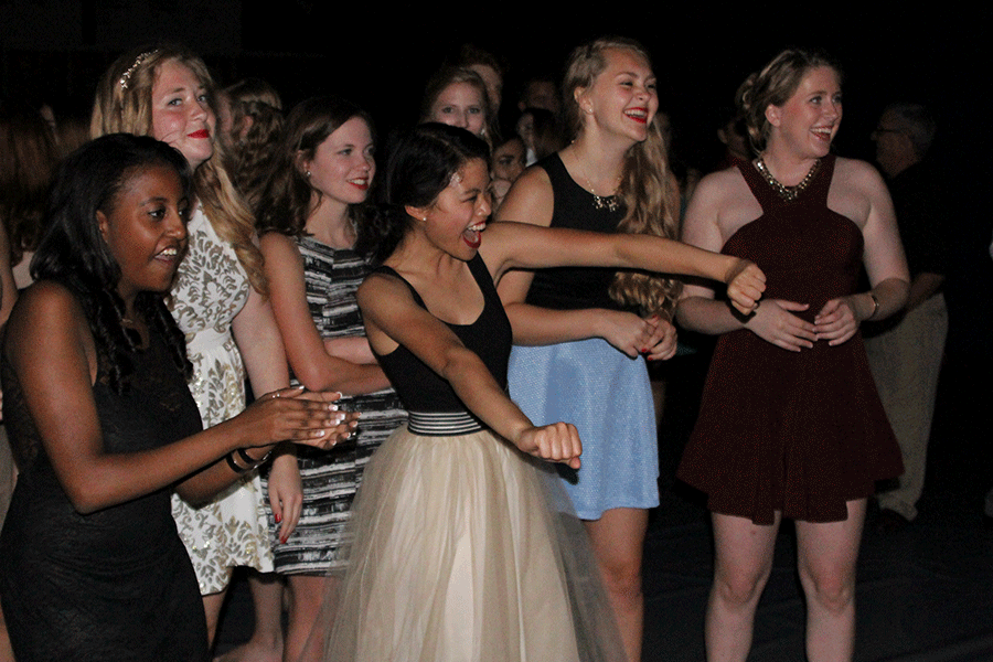 Senior girls cheer for their classmates during a dance battle at the Homecoming dance on Saturday, Sept. 19.