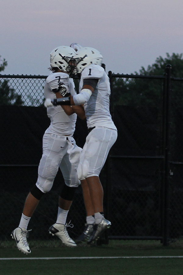 Seniors Christian Jegen and Lucas Krull chest-bump after a touchdown at the football game vs. Aquinas on Friday, Sept. 4.