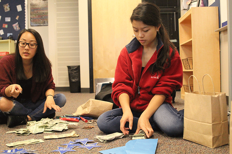 Senior Camille Gatapia counts and sorts out money from the fundraiser on Tuesday, Oct. 6.