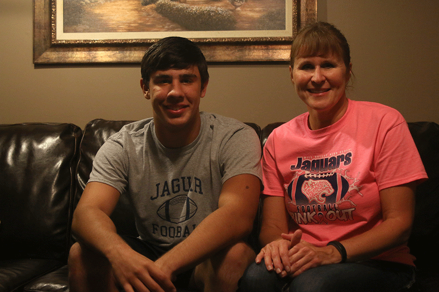At their home, sophomore Ike Valencia and his mom, Debbie Valencia, take a seat together on Monday, Oct. 12.