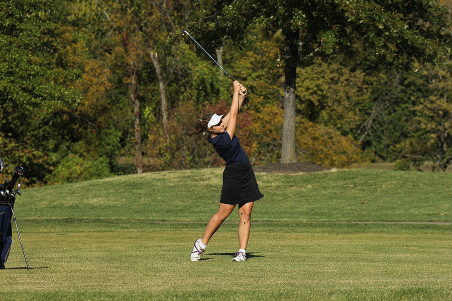 Tracking her ball through the sky, junior Meg Green chips the ball onto the putting green.