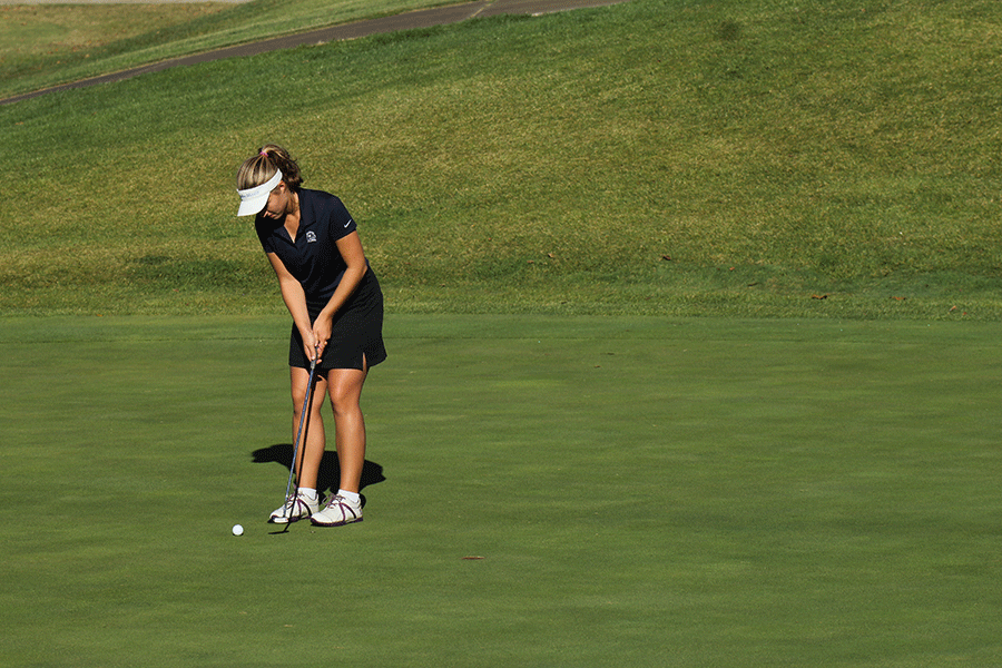 Junior Meg Green lines herself up for putt on Tuesday, Oct. 13. Green placed third individually, with a score of 84.