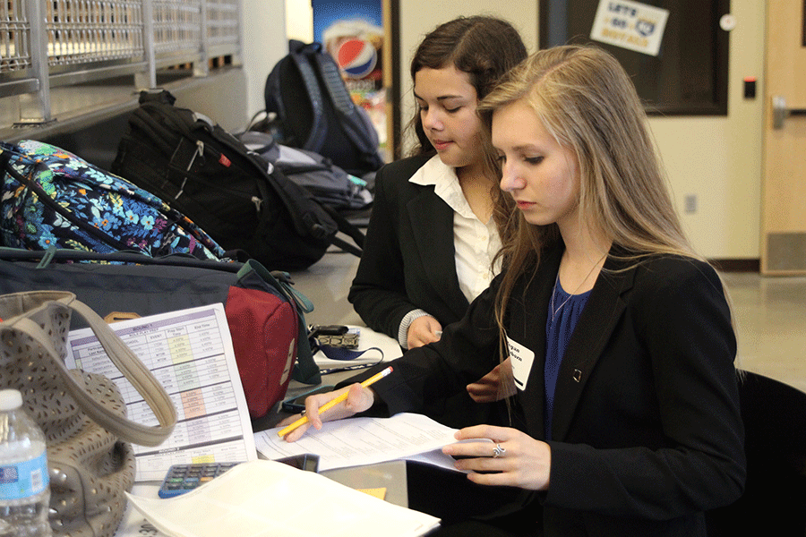Focused on a practice test, senior Megan Feuerborn studies before her competition at the Lansing High School DECA  meet on Tuesday, Oct. 27.