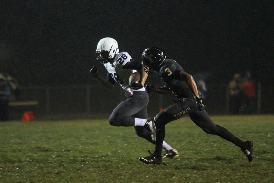 Sprinting towards the end zone, sophomore Ike Valencia is pursued by a Turner player during the away game against Turner High School on Friday, Oct. 30.