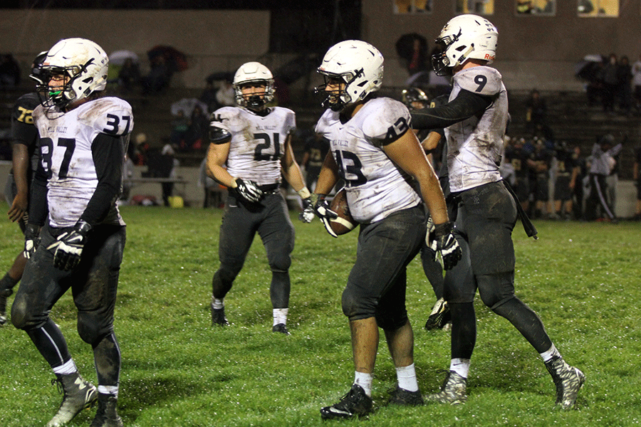 After recovering a fumble, defensive lineman Hersimran Aujla is clapped on the back by senior Cole Morris.