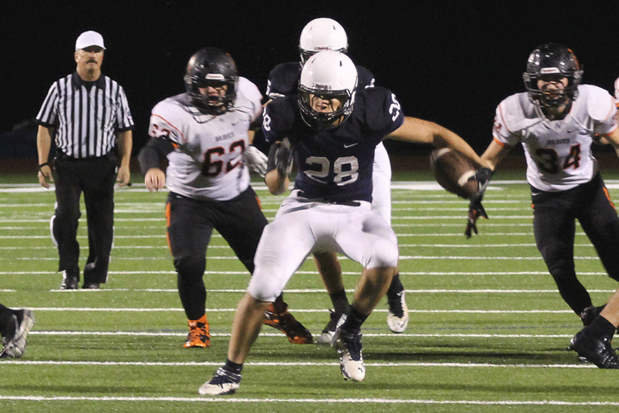 Breaking through the Braves defense, sophomore Ike Valencia carries the ball for a first down. The Jaguars defeated the Bonner Springs Braves 48-14 in their second playoff game, clenching the Jaguars a spot in the playoffs. 