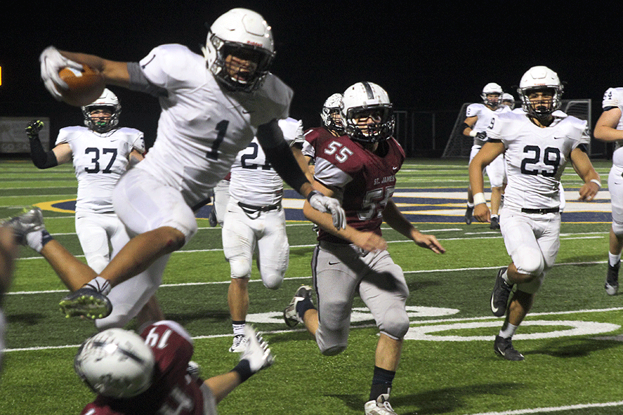Jumping over the defense, senior Christian Jegen runs for a touchdown. The Jaguars defeated the St. James Thunder on Friday, Oct. 16 with a final score of 45-14.