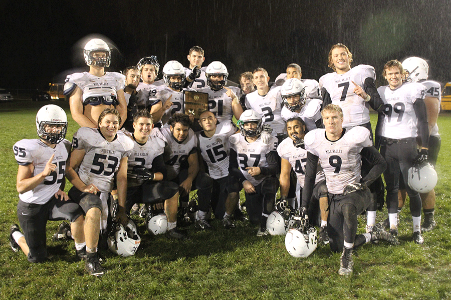 Seniors pose with their district trophy on Friday, Oct. 30, after a 48-0 win over the Turner Bears, ending the regular season with a record of 8-1 and a district record of 3-0.