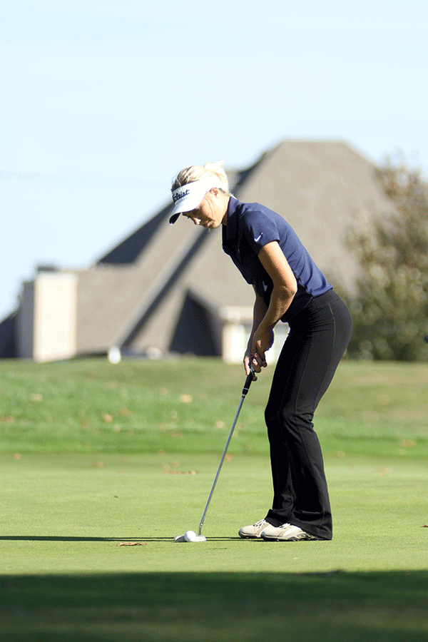Lining up with the hole, junior Claire Anderson gets ready for the putt.