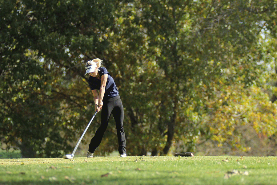 Junior Claire Anderson uses her driver to tee off.