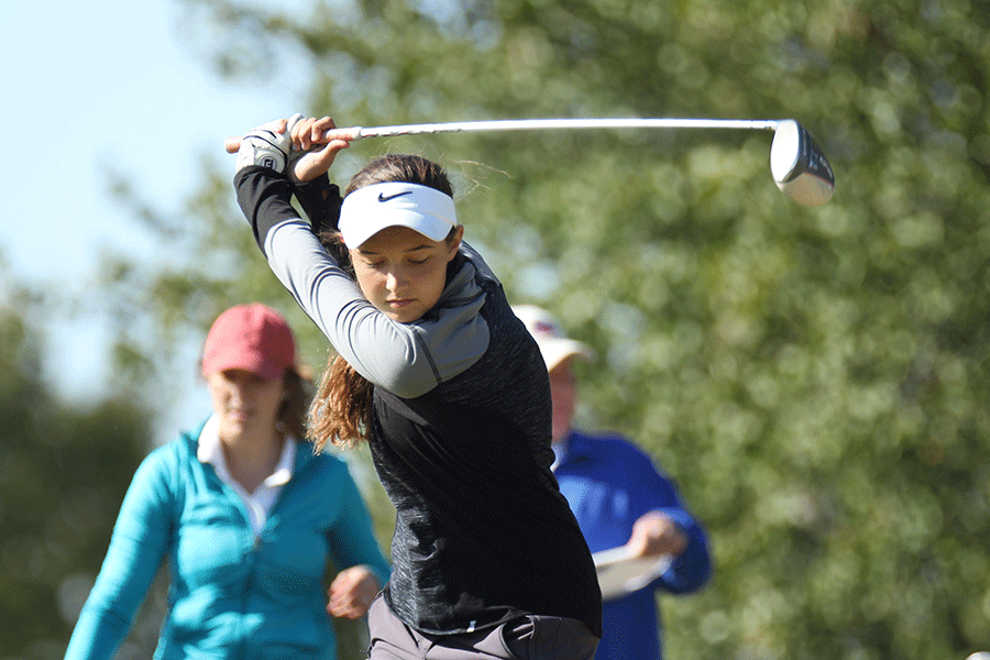 Bringing her club back to swing, freshman Sarah Lawson focuses on the ball.