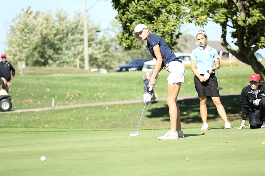 Sophomore Bella Hadden looks on, as she putts the ball.