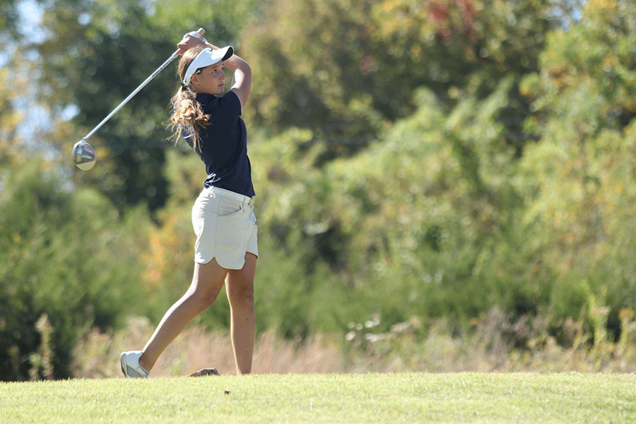 After her swing, freshman Sarah Lawson watches her ball fly across the green at regionals on Tuesday, Oct. 13. The teams second place finish placed them a spot to compete at state on Monday, Oct. 19.