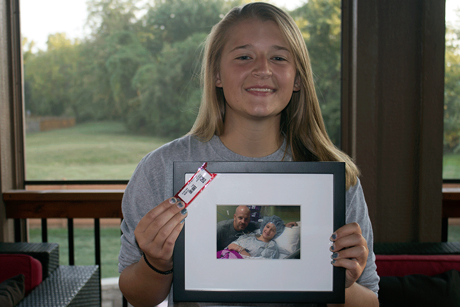 Sitting in her home, senior Whitney Epps displays a photo taken after her 12 hour brain surgery. I was very loopy during the operation, but I knew what was going on, Epps said. It felt pretty weird, but I think it was kind of cool.