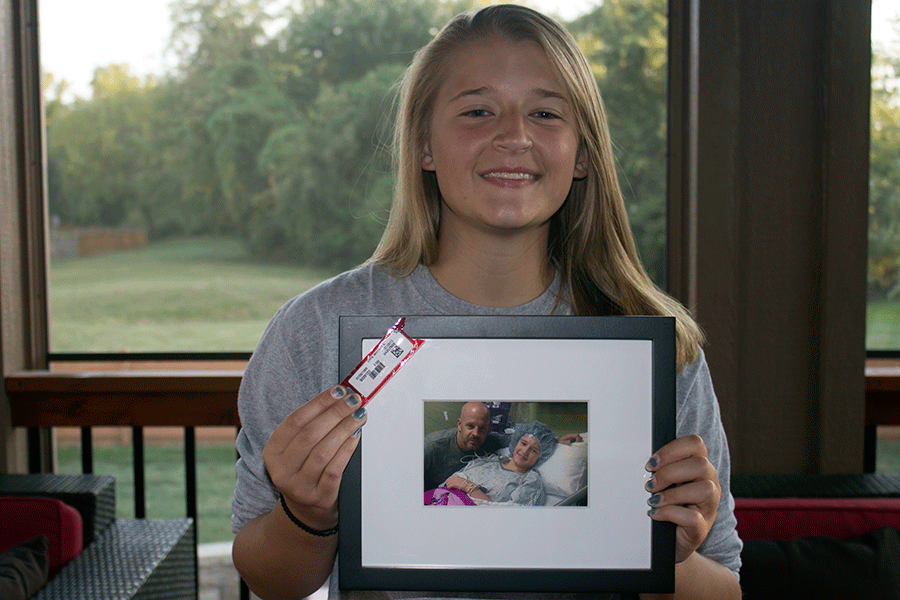 Sitting in her home, senior Whitney Epps displays a photo taken after her 12 hour brain surgery. "I was very loopy during the operation, but I knew what was going on," Epps said. "It felt pretty weird, but I think it was kind of cool."