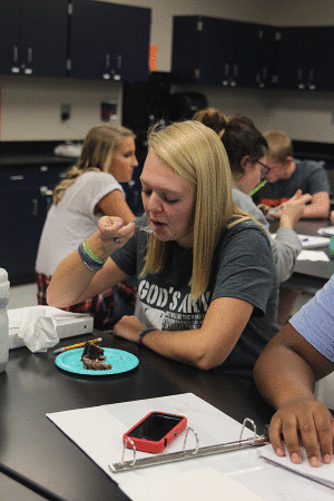 Junior Skyler King eats cake during physics teacher Chad Brown's blue 3 class on Monday, Sept. 28.