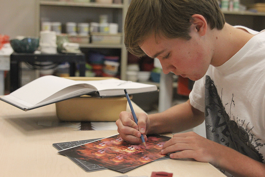 Sophomore Tyler Orbin takes his time on the colored portion of his AP Studio Art collage on Friday, Oct. 9. I usually just do graphite drawings, but sometimes I like to branch out and try to use different colors and mediums, Orbin said.