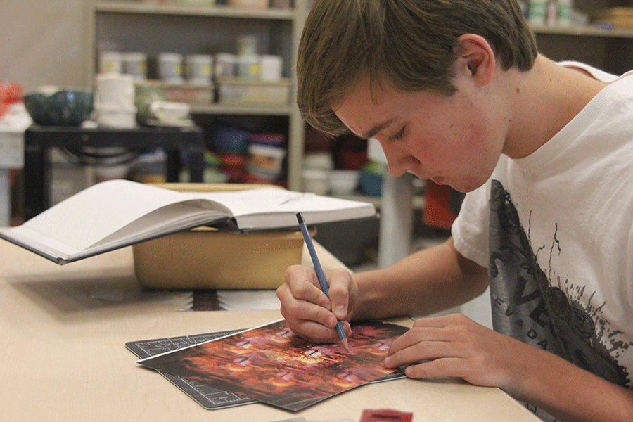 Sophomore Tyler Orbin takes his time on the colored portion of his AP Studio Art collage on Friday, Oct. 9. "I usually just do graphite drawings, but sometimes I like to branch out and try to use different colors and mediums," Orbin said.