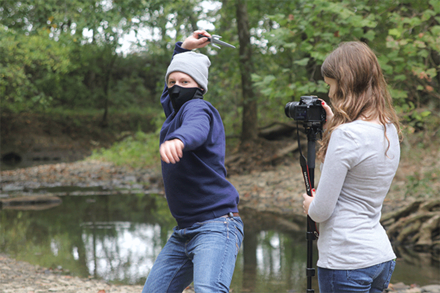 To prepare for the Halloween Film Fest, sophomore director Julia Feuerborn records one of the main characters, junior Brady Rolig on Monday, Oct. 5. “[The hardest part is] actually getting the shots and trying to take it from a script to an actual movie,” Feuerborn said. “We obviously don’t have special effects or anything, we all have to do this out of what we can find.”