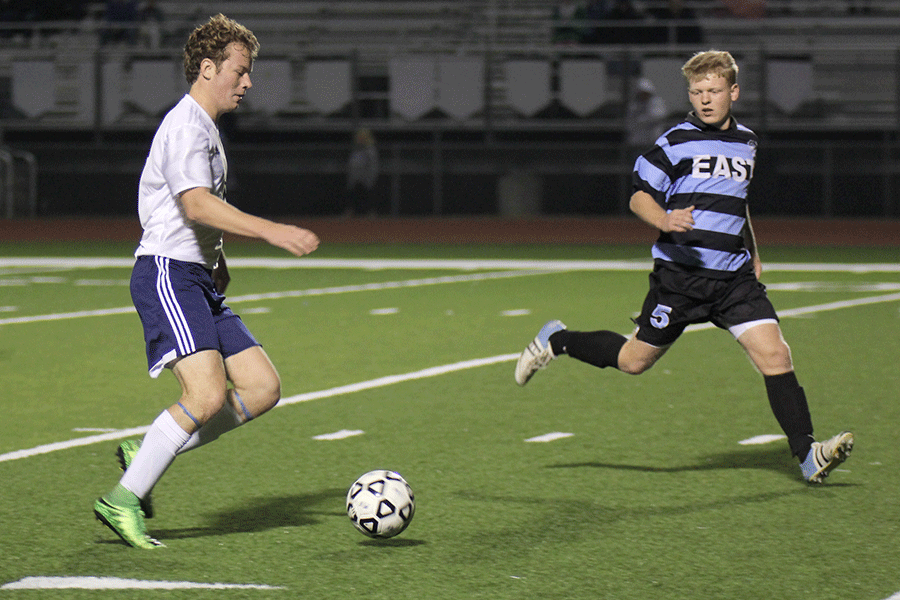 Senior Zac Kornis dribbles down field while looking to score a goal.