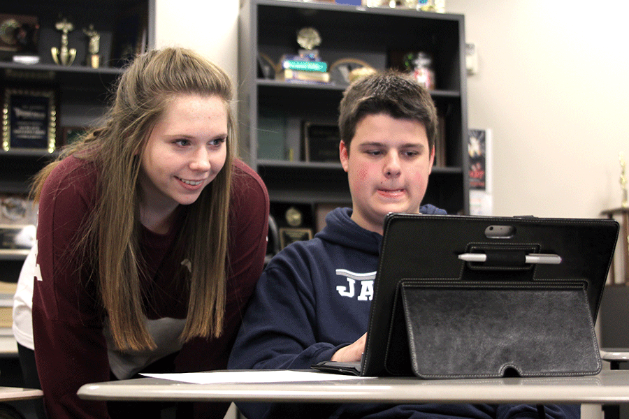 In Advanced Debate, senior Jack Booth helps junior Sydney Hall with a counter plan on Thursday, Oct. 29, in preparation for the meet at Shawnee Mission Northwest on Saturday, Oct. 31. 