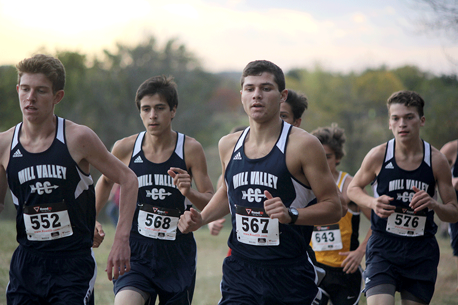 Senior Derek Meeks sticks with a pack of Mill Valley runners at the beginning of the race. Meeks placed 1st overall.