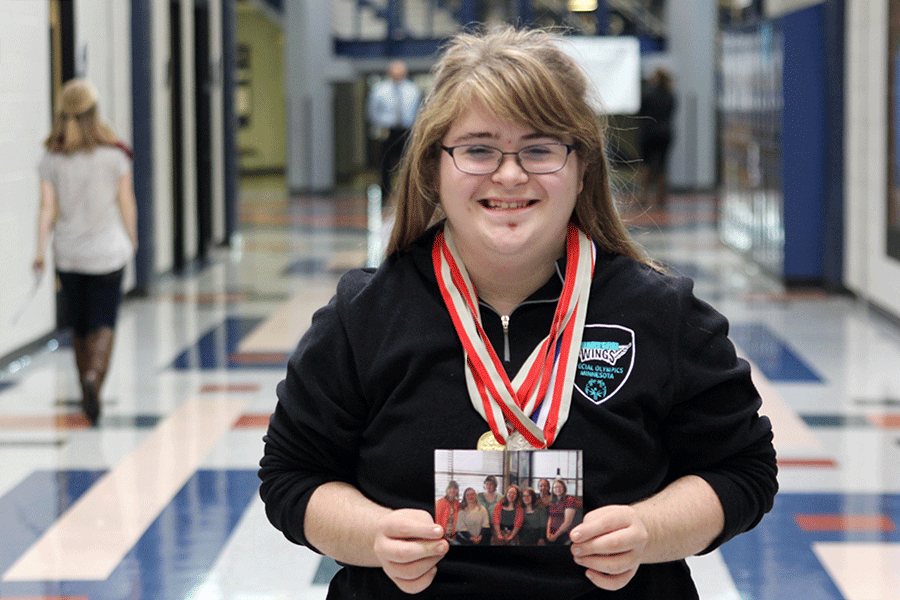 Showcasing a photo of her Minnesota friends and adorning medals from bowling, swimming and more, senior Sara Pietig grins on Thursday, Sept. 15. “[I decided to get involved] to get to know other people more and to see what they want to do after high school,” Pietig said. “[My favorite activity] is girl’s swim because it’s really fun and really active.” 