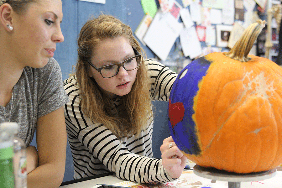 Decorating her pumpkin, senior Ally Henderson focuses to make recreate a famous artwork. 