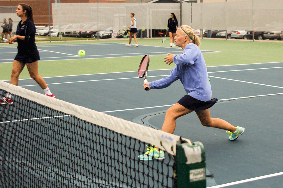 Paige+Wiebe+warms+up+for+her+tennis+match.+