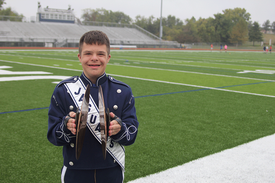 Holding his cymbals, freshman Matt Santaularia stands on the football field during picture day on Monday, Oct. 5.