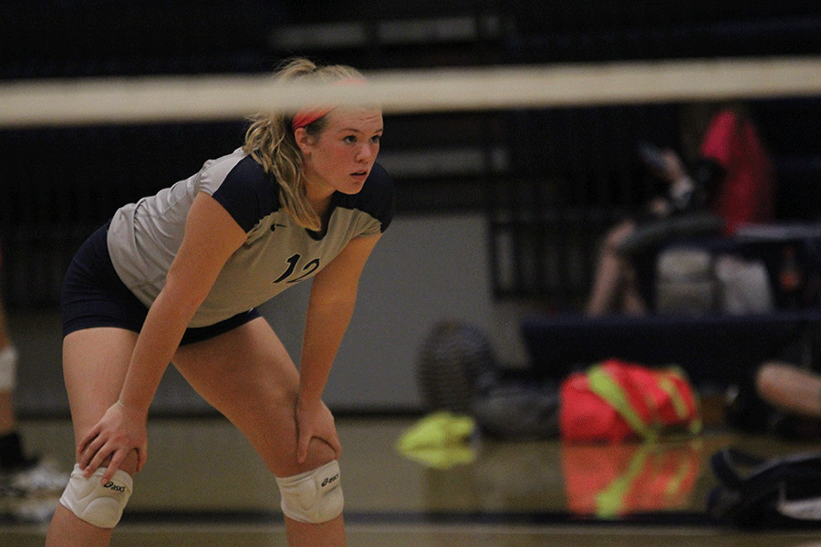 Getting in position, senior Catie Kaifes watches as the De Soto Wildcats serve.