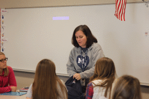 Family and Consumer Sciences teacher Eileen Gray shows students of her Family Studies class what is on the inside of an empathy belly. 