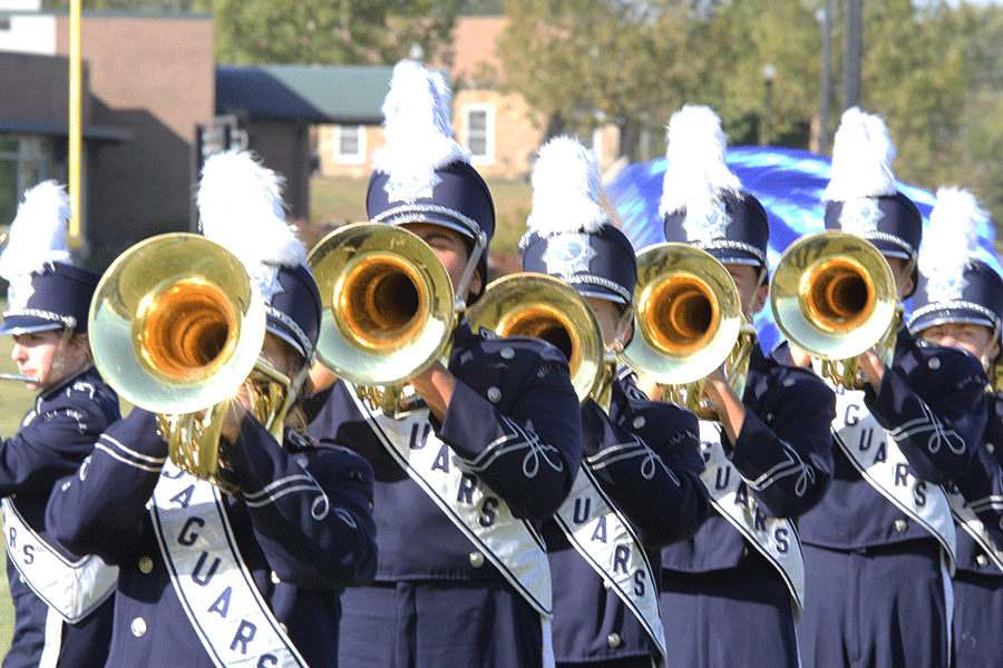 Mellophoneers from the  marching band stand in formation during their competition on Wednesday, Oct. 7.