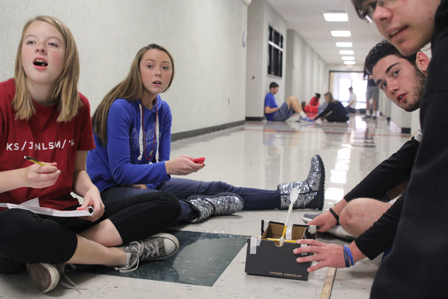Testing their marshmallow launcher in Physics, juniors Taylor Weber and Alexis Strauss and senior Joe Wilson watch a marshmallow fly on Wednesday, Oct. 26.