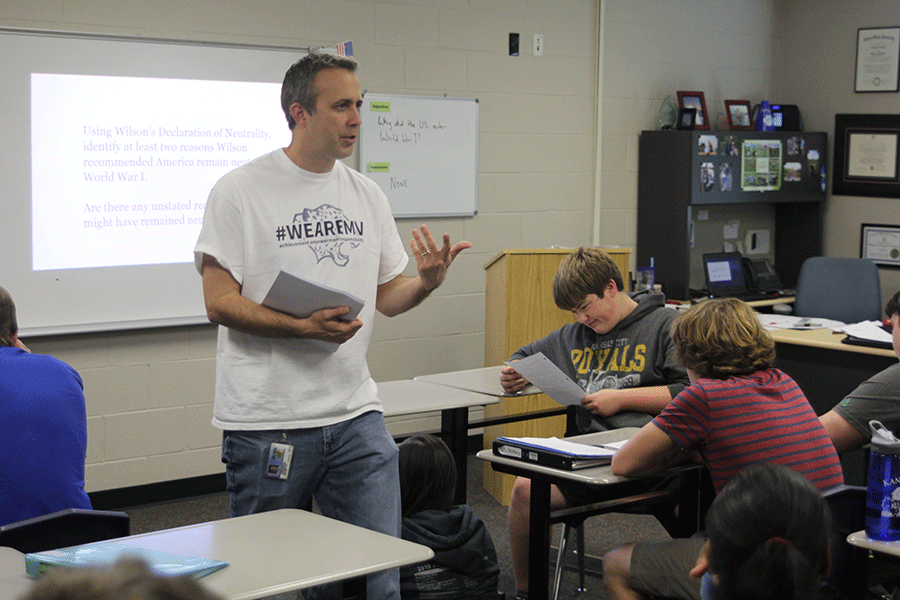 After the review over the reading on WWI students had for homework, social studies teacher Jeff Wieland passes out the newly assigned homework at the beginning of class on Friday, Nov. 6.