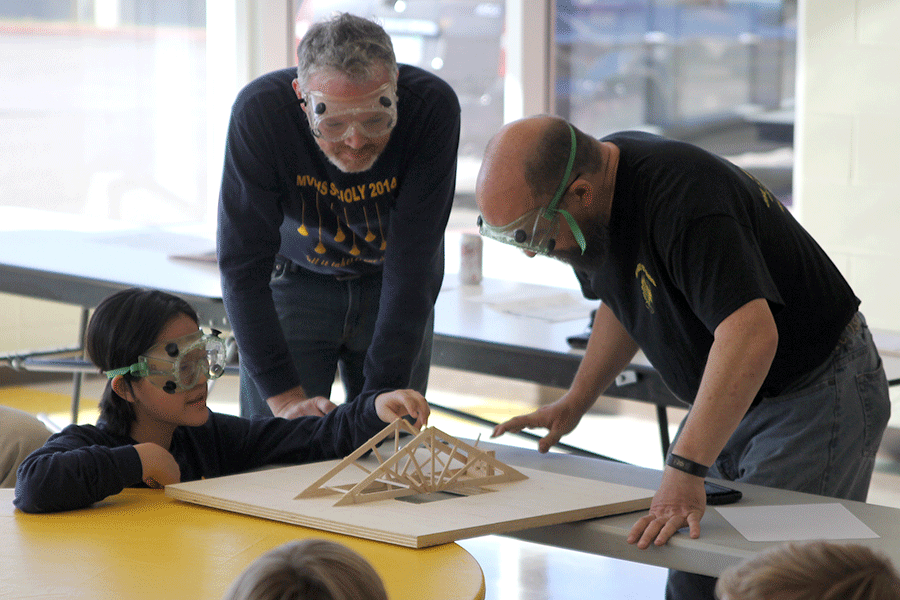 After moving from event to event, senior T-Ying Lin participates in the bridge building event during the Science Olympiad meet at Shawnee Mission South on Saturday, Nov. 14.