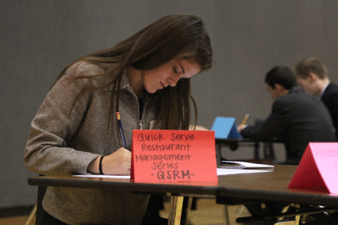 While in the prep room at the Blue Valley West DECA competition on Wednesday, Nov. 4., junior Meghan Burke gets ready for her upcoming series.