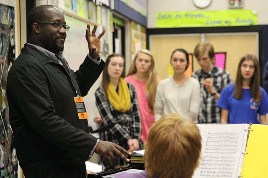 During choir on Wednesday, Nov. 11, clinician John Stafford helps the Jag Chorale students prepare for their winter concert.