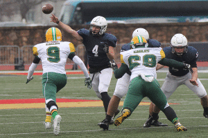 With the Eagles defense approaching, senior quarterback Logan Koch passes to an open teammate. The Jaguars defeated the Bishop Carroll Eagles 35-14 in the 5A state championship game, giving the Jaguars their first football state championship title in school history. 