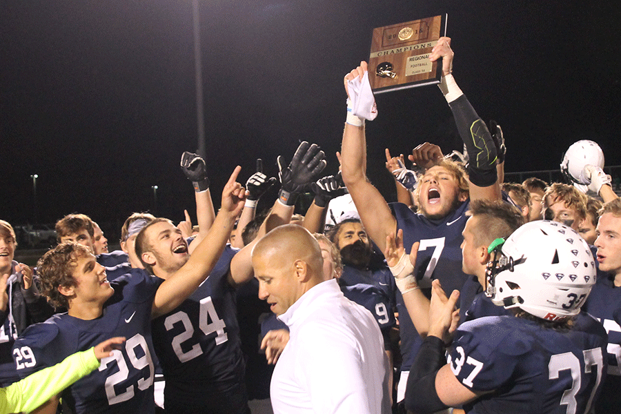 Senior Lucas Krull hoists up the regionals trophy in celebration of a 49-0 win over the Leavenworth Pioneers in the first round of playoffs on Friday, Nov. 6. The Jaguars will advance to play the Pittsburg Purple Dragons in the sectional round of playoffs at Pittsburg on Friday, Nov. 13. “We know whats on the line,” senior Lucas Krull said. “We got to go out there and we just need to show everyone what we are about.”