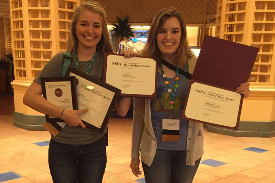 Posing for the camera, seniors Karissa Schmidt and Liz Fleming hold up the awards received on Saturday, Nov. 14.