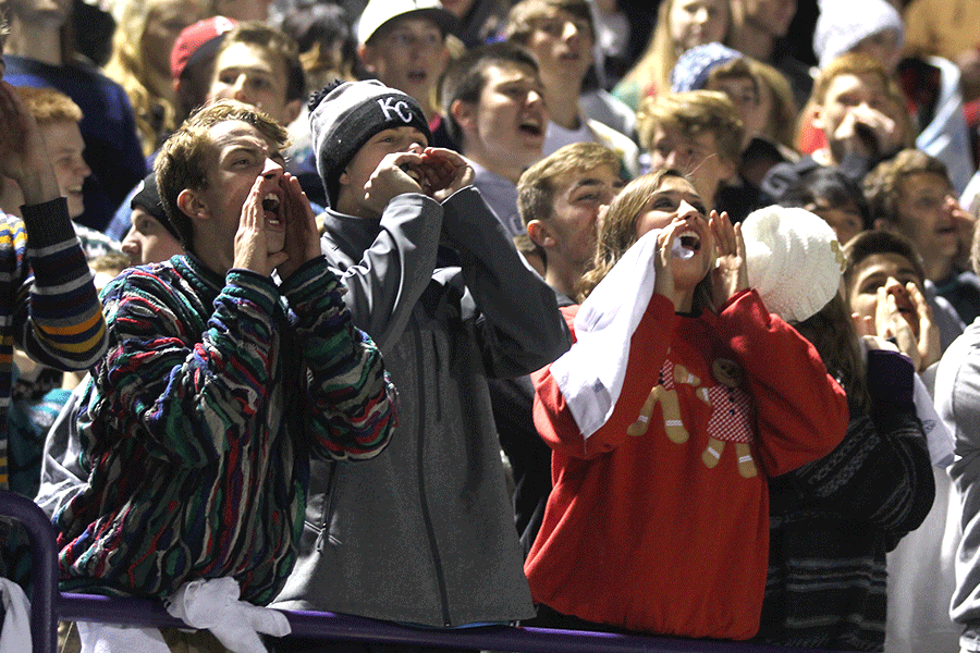 Seniors Shane Calkins, Tanner Reed and Katie Burke all cheer.