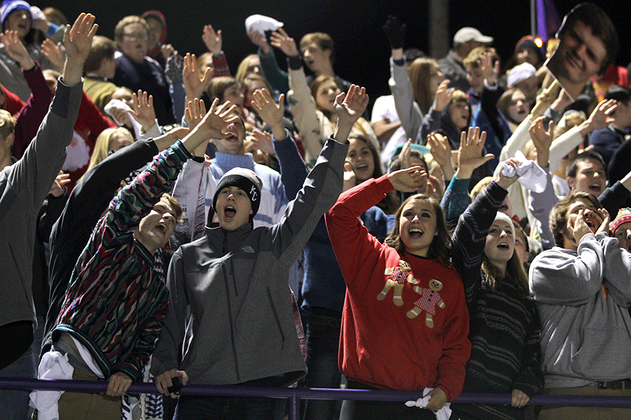 As the game nears its end, senior Katie Burke waves with the student section goodbye to the other team.