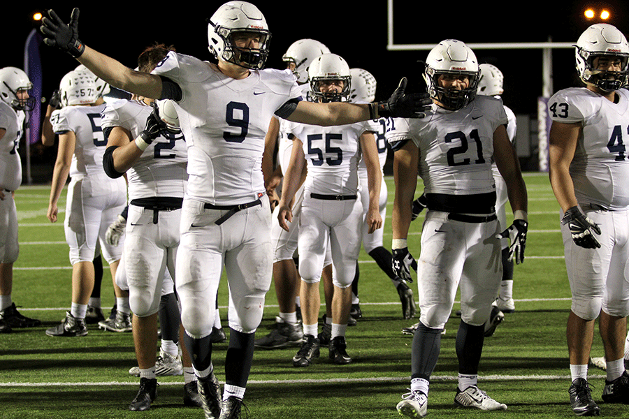 Senior Cole Morris waves his hands in celebration of the win.