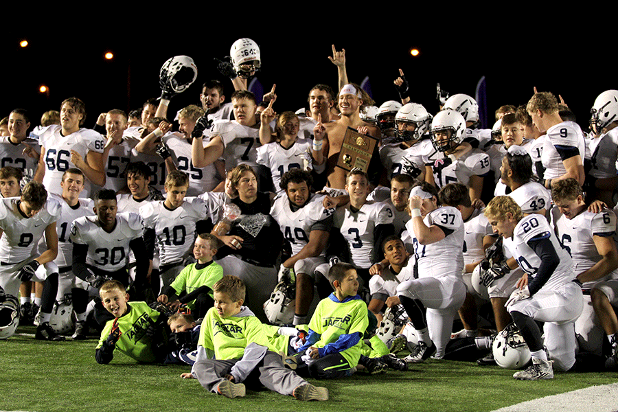 After beating the Pittsburg Purple Dragons 56-21,the Jaguars pose for pictures with the sectional trophy on Friday, Nov. 13. The team will advance to play Saint Thomas Aquinas in for the sub-state championship at home on Friday, Nov. 20.