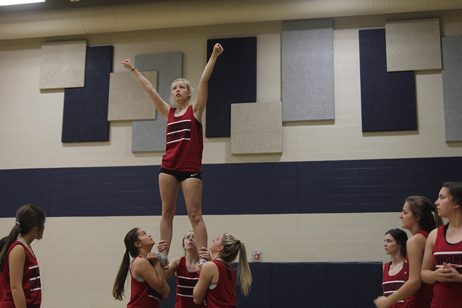 After a week of sitting out due to a concussion, junior Lexi Moore returns to cheering.