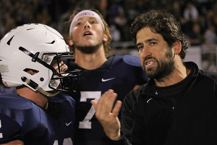 Coach Mike Strack discusses the play with junior Brady Garrison. 