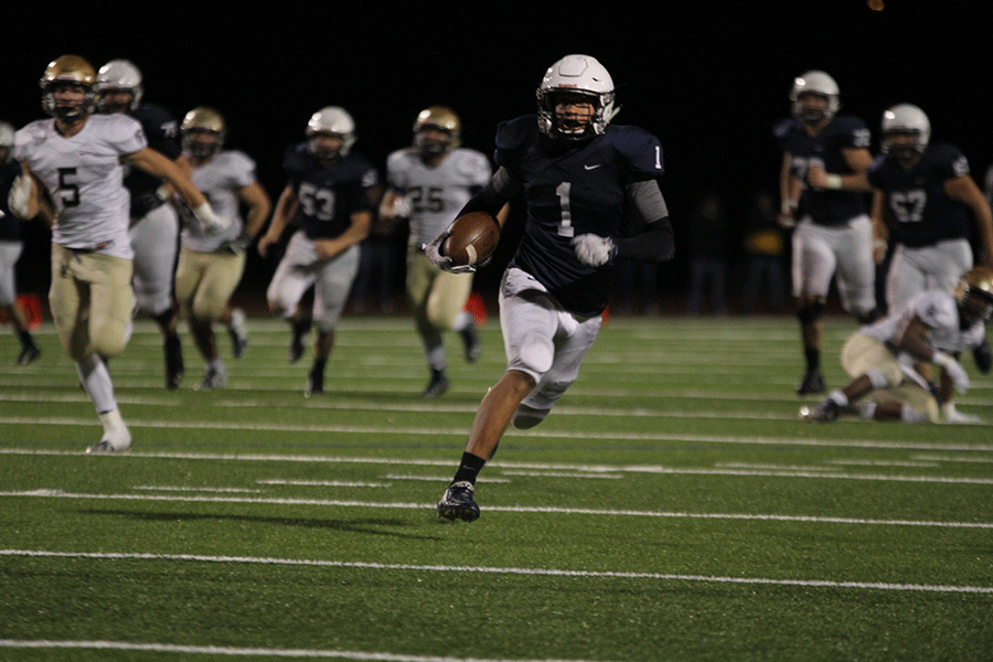 Senior Christian Jegen carries the ball to the end zone. 
