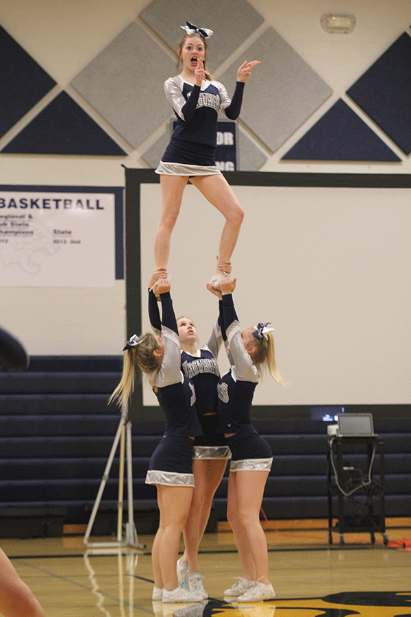 Sophomore Natalie Cooper stunts on Friday, Nov. 27.