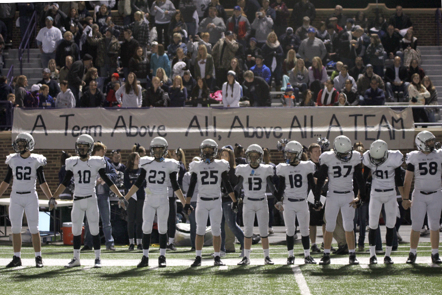 The Jaguars hold hands as they wait for news from their captains about the coin toss.